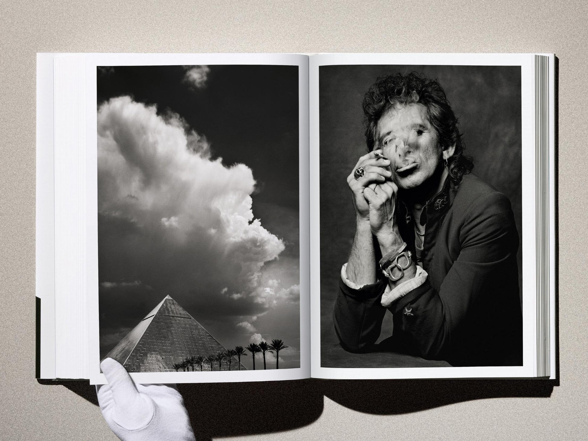 Two page Kaos spread: left image of a pyramid with palm trees under dramatic clouds; right image a black and white portrait of a man smoking, wearing bracelets.