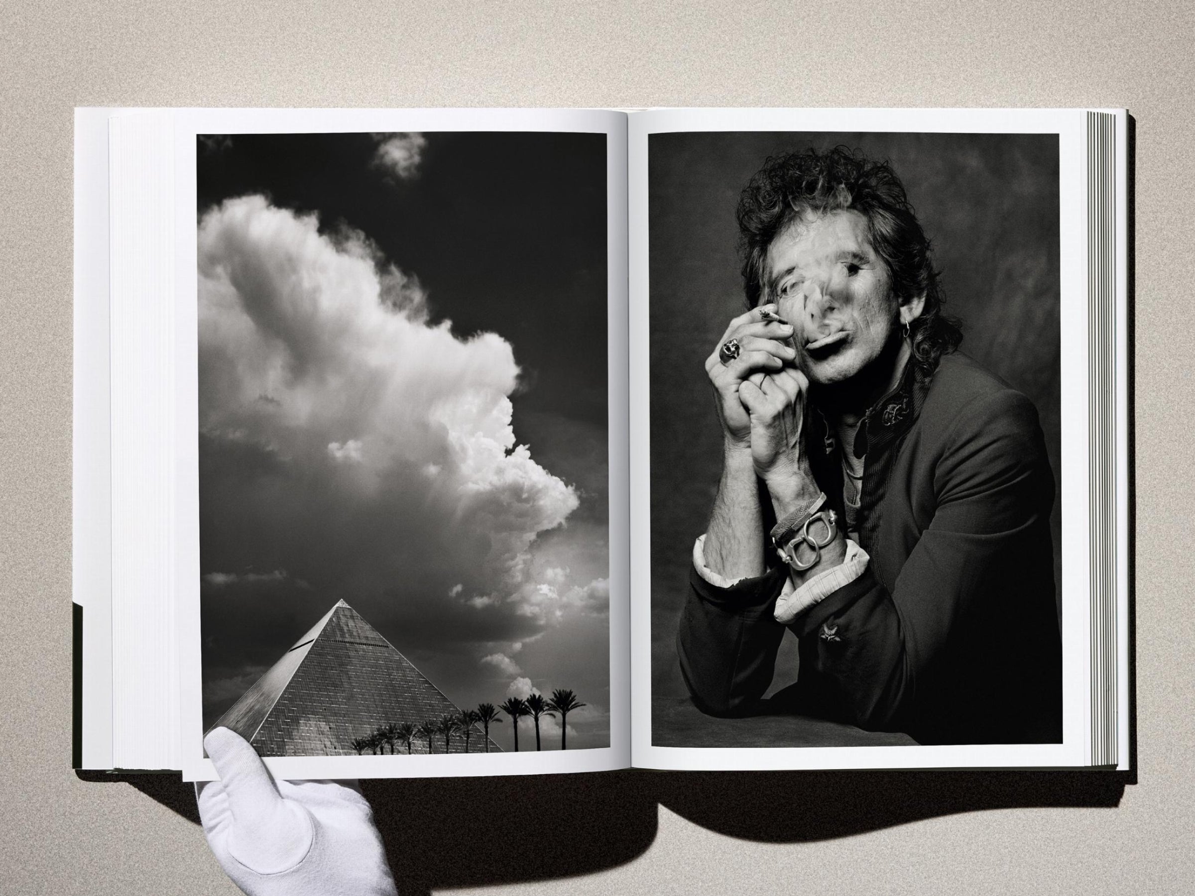 Two page Kaos spread: left image of a pyramid with palm trees under dramatic clouds; right image a black and white portrait of a man smoking, wearing bracelets.
