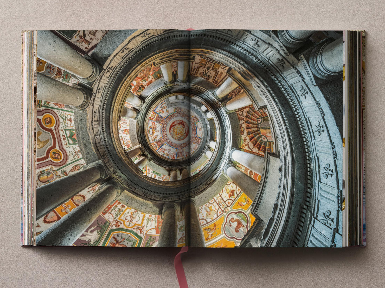 Open Massimo Listri Italian Palaces spread showing a circular domed interior with columns and frescoes