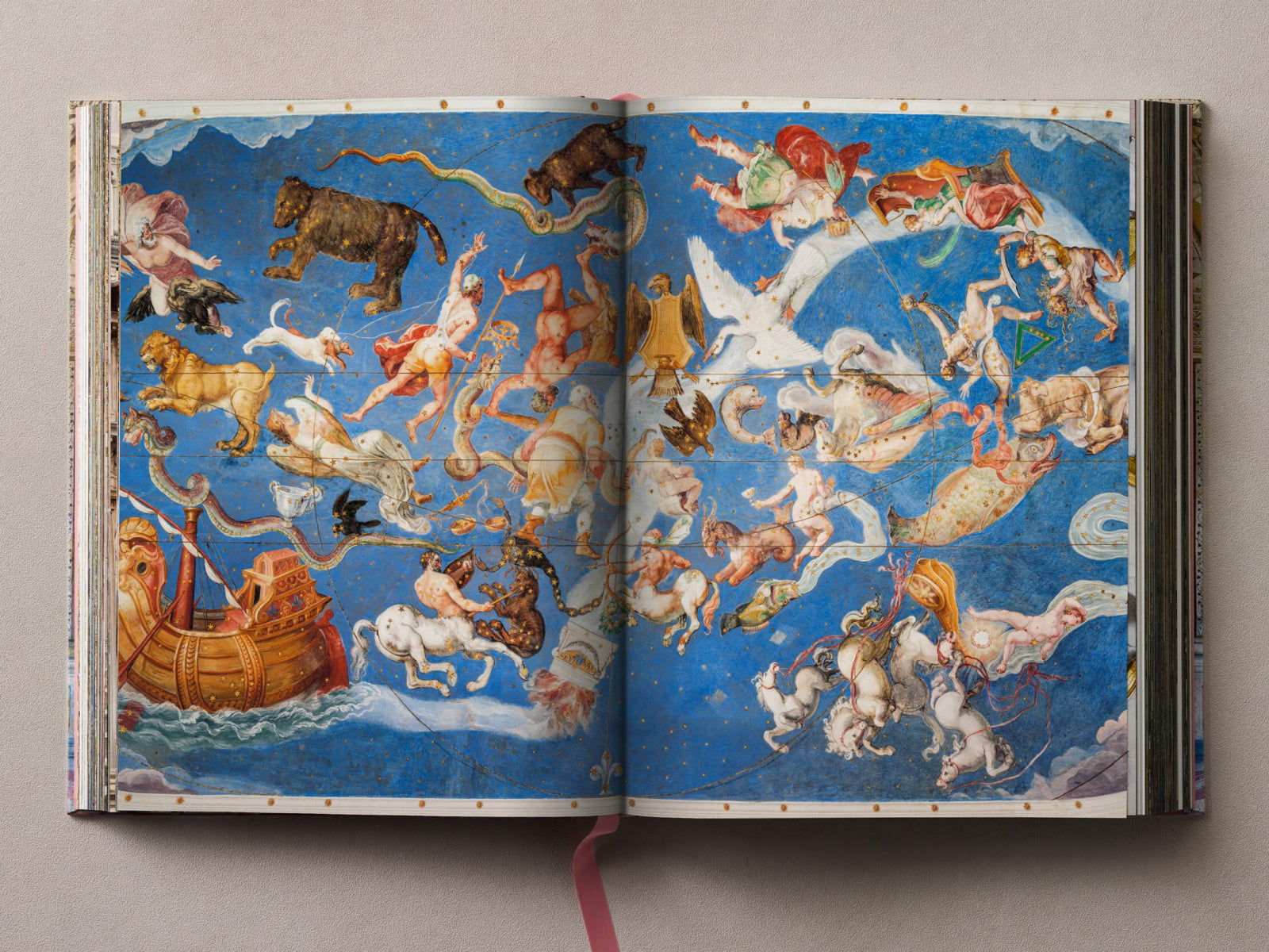 Vibrant blue palace ceiling fresco depicting mythological figures and ships across the span.