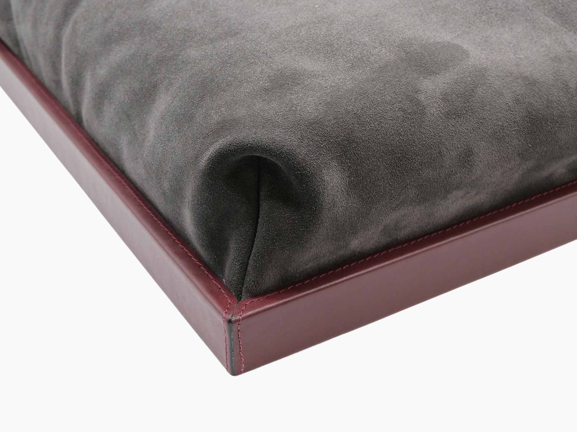 Close up of Teddy Bed Tray with burgundy leather frame and grey suede padded surface.