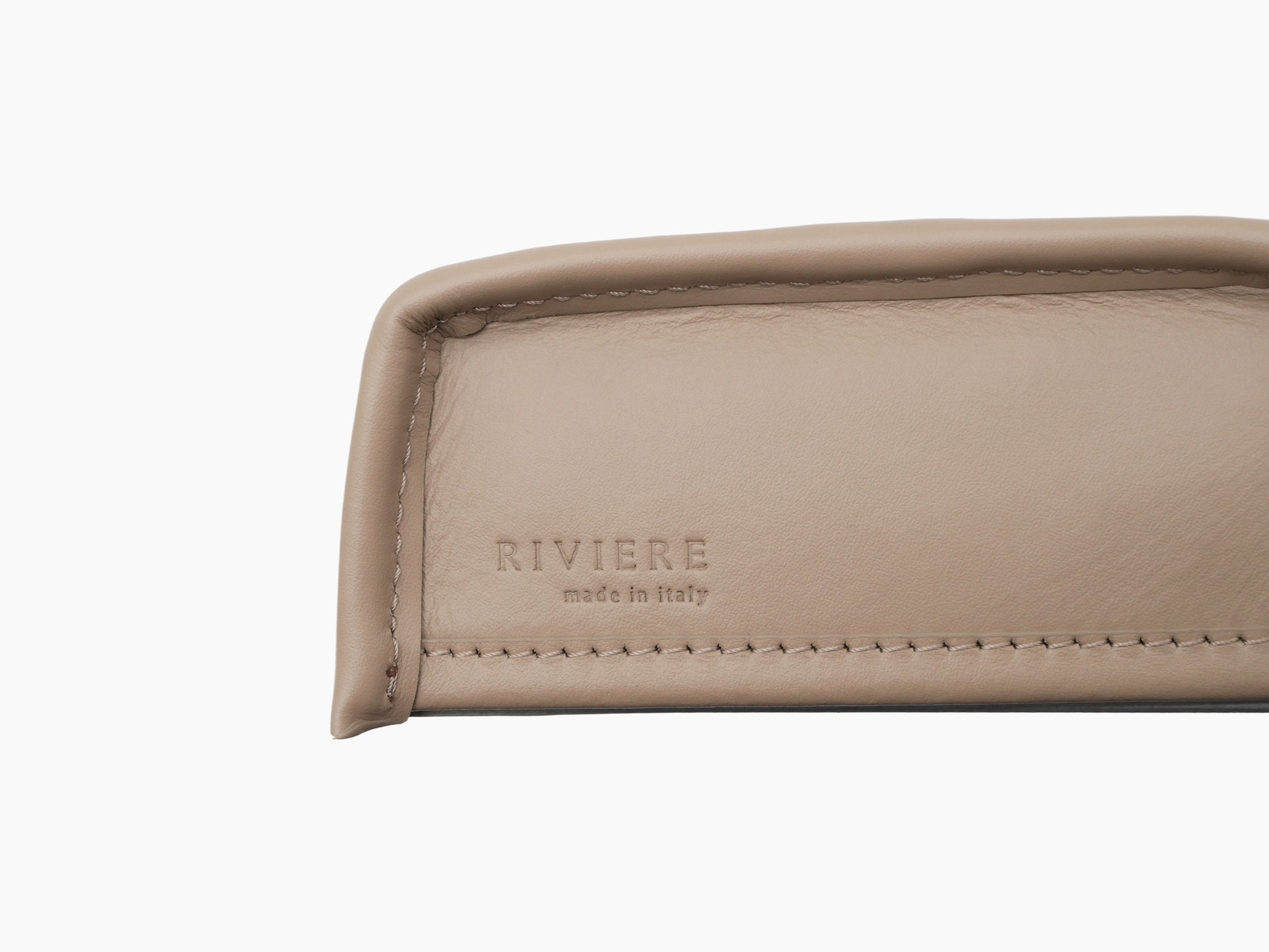Close-up of beige quilted leather tissue box cover showing diamond stitching and RIVIERE stamp