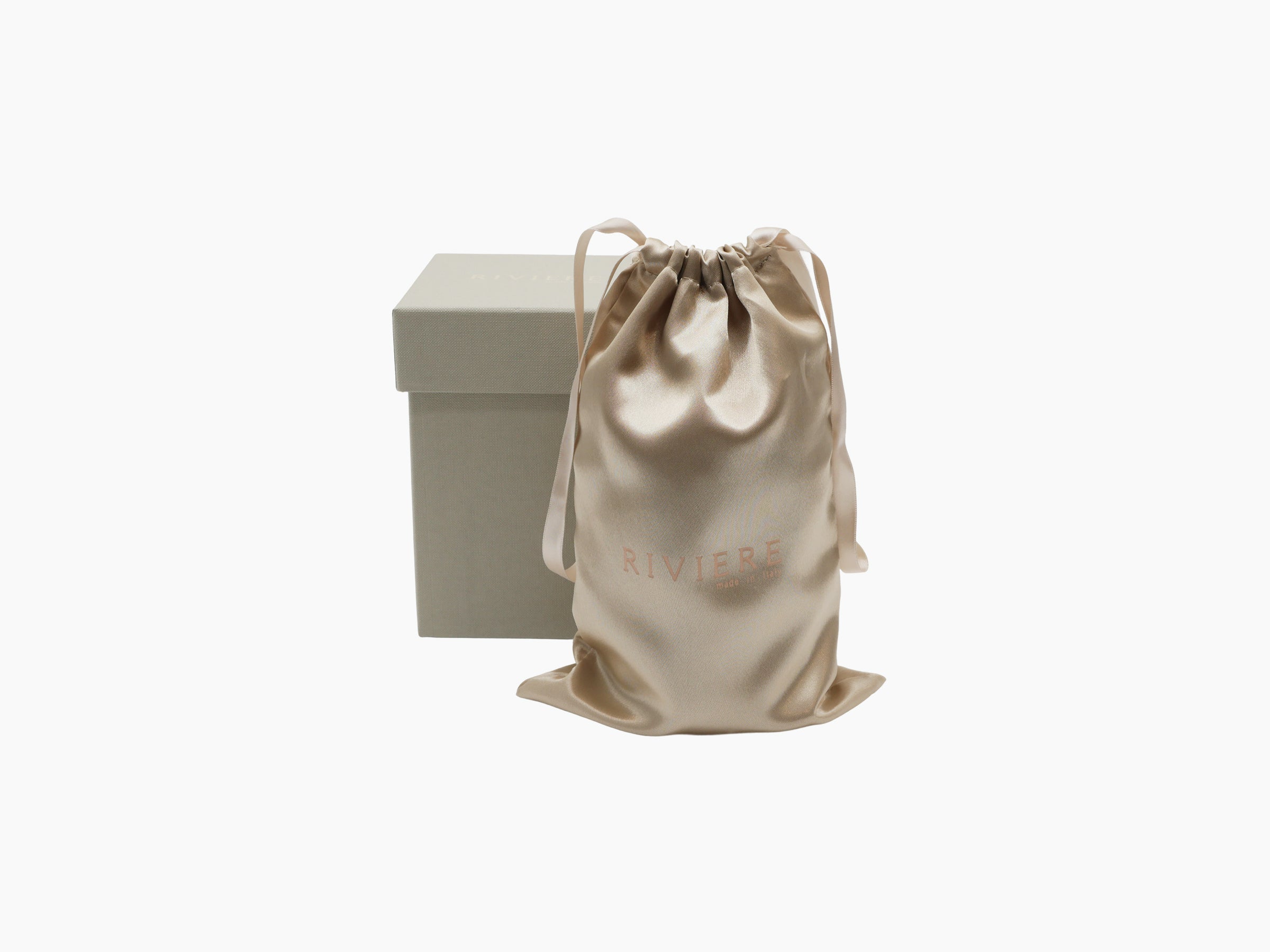 Beige satin drawstring pouch with RIVIERE branding next to a matching box, shown as part of the packaging