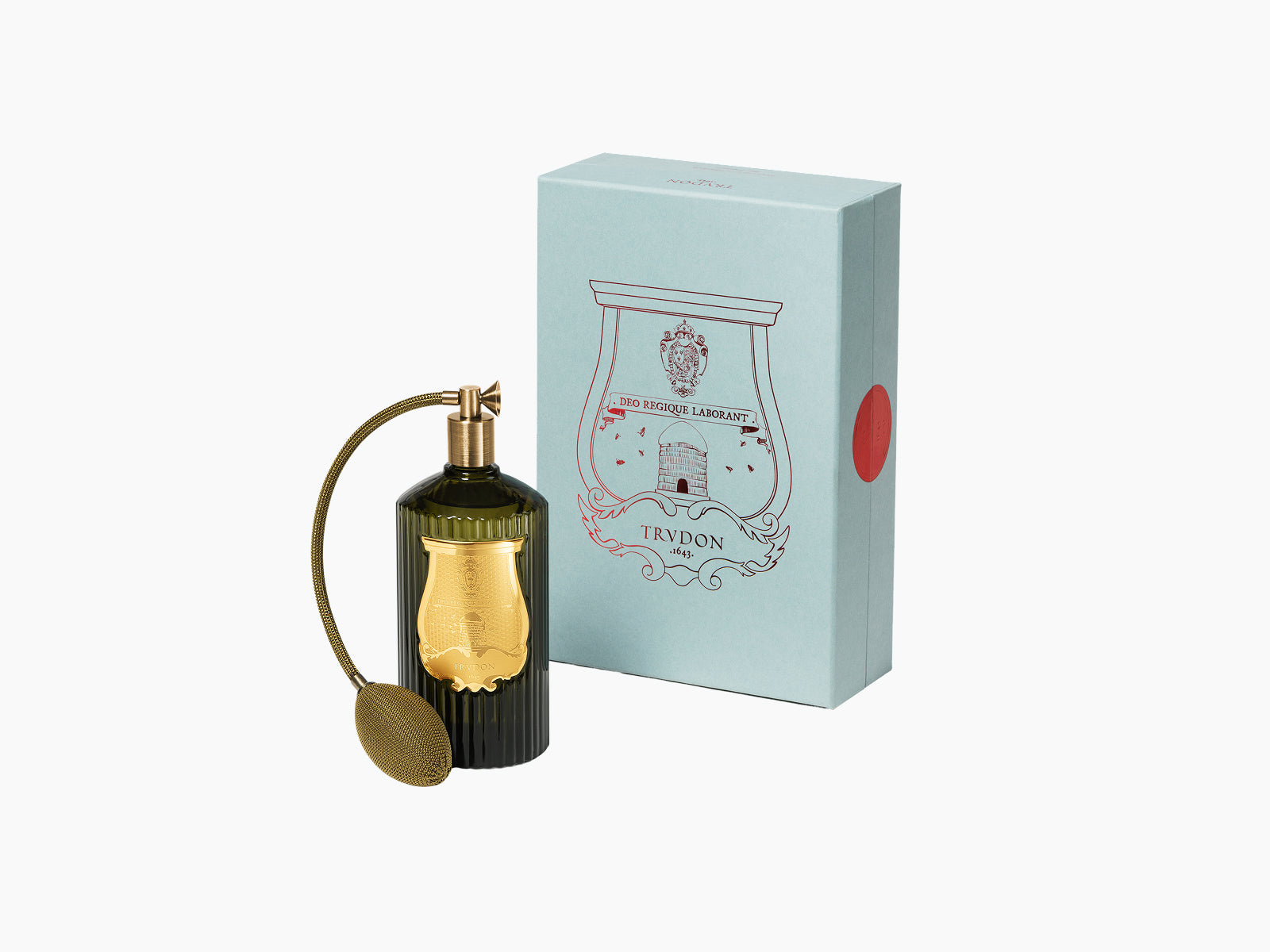 Ernesto Leather and Tobacco room spray in a ribbed dark bottle with a gold crest label beside a pale blue box.