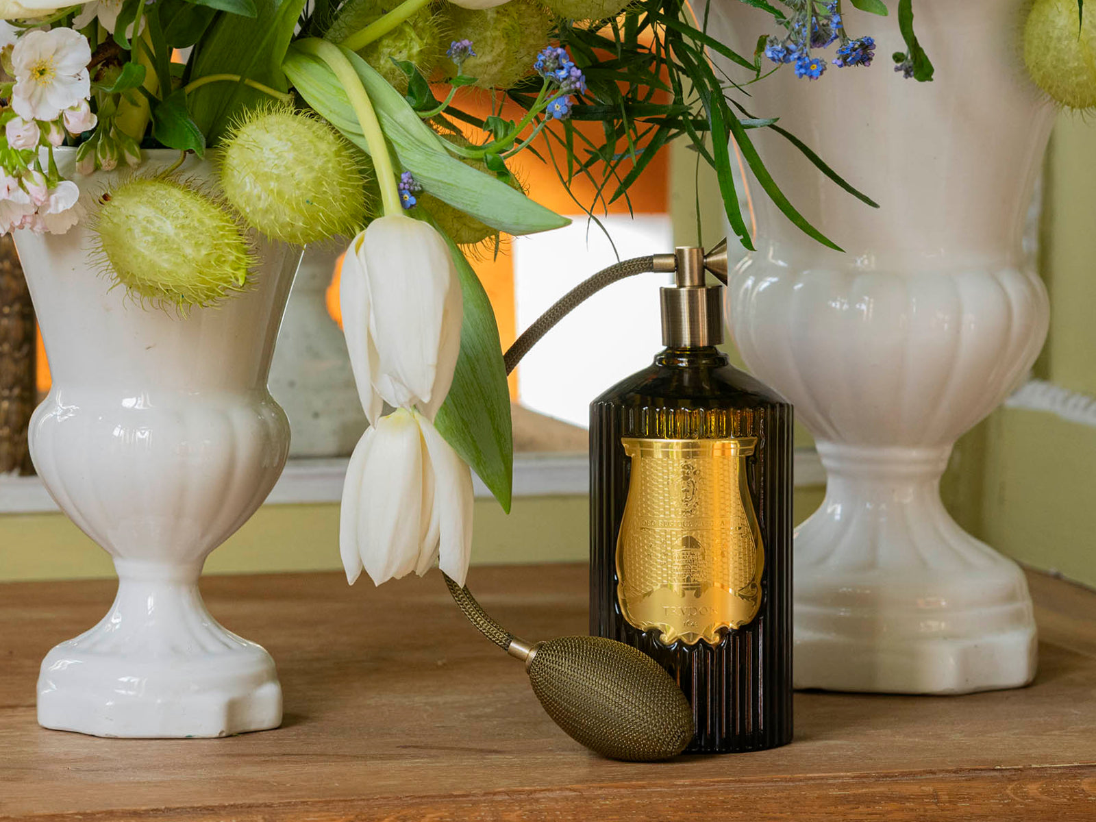 Ernesto Leather and Tobacco room spray with a ribbed dark bottle brass nozzle and curved hose gold label.