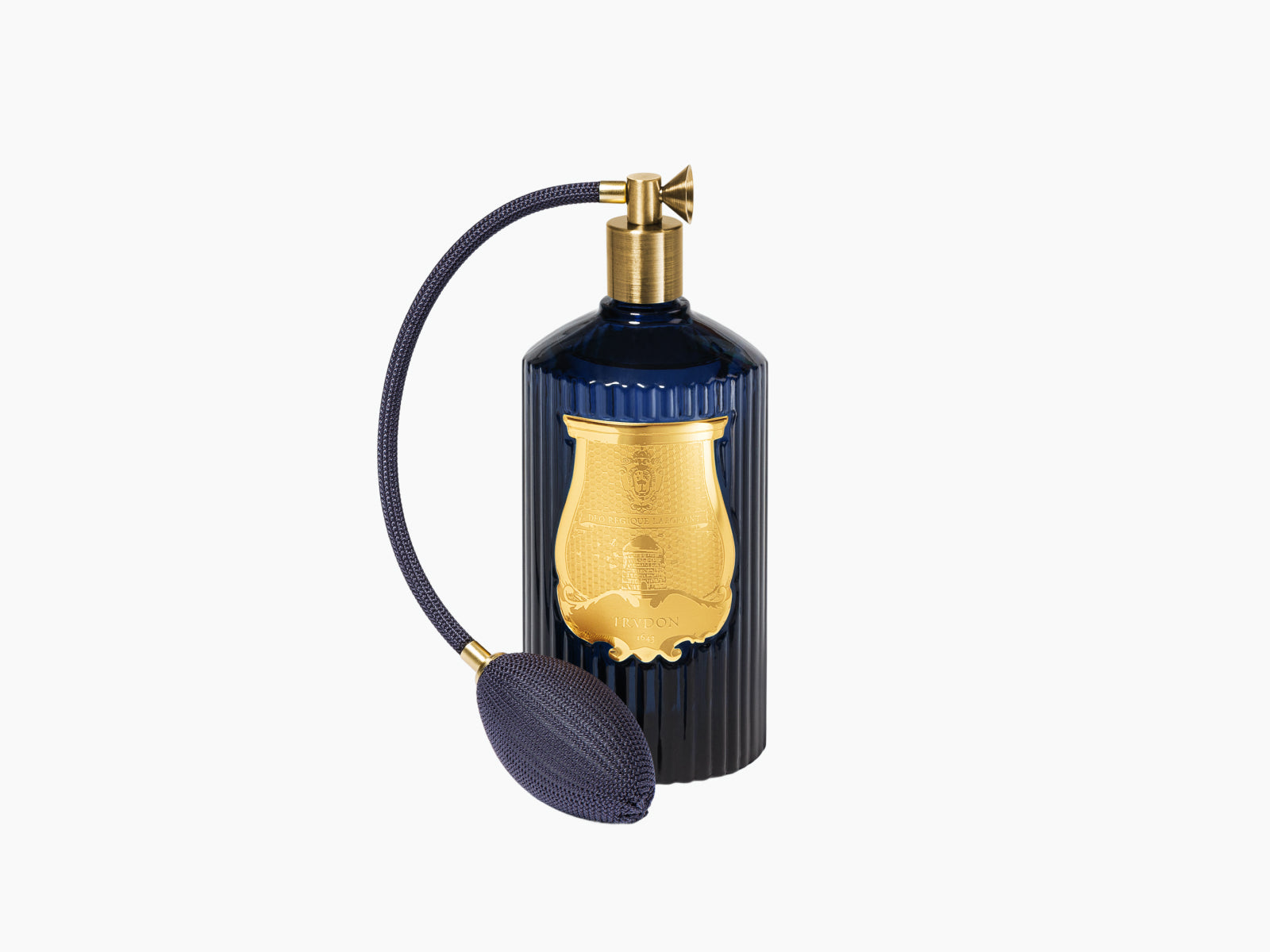 Reggio Hint of citrus from Calabria room spray in deep blue fluted glass with a woven navy pump.