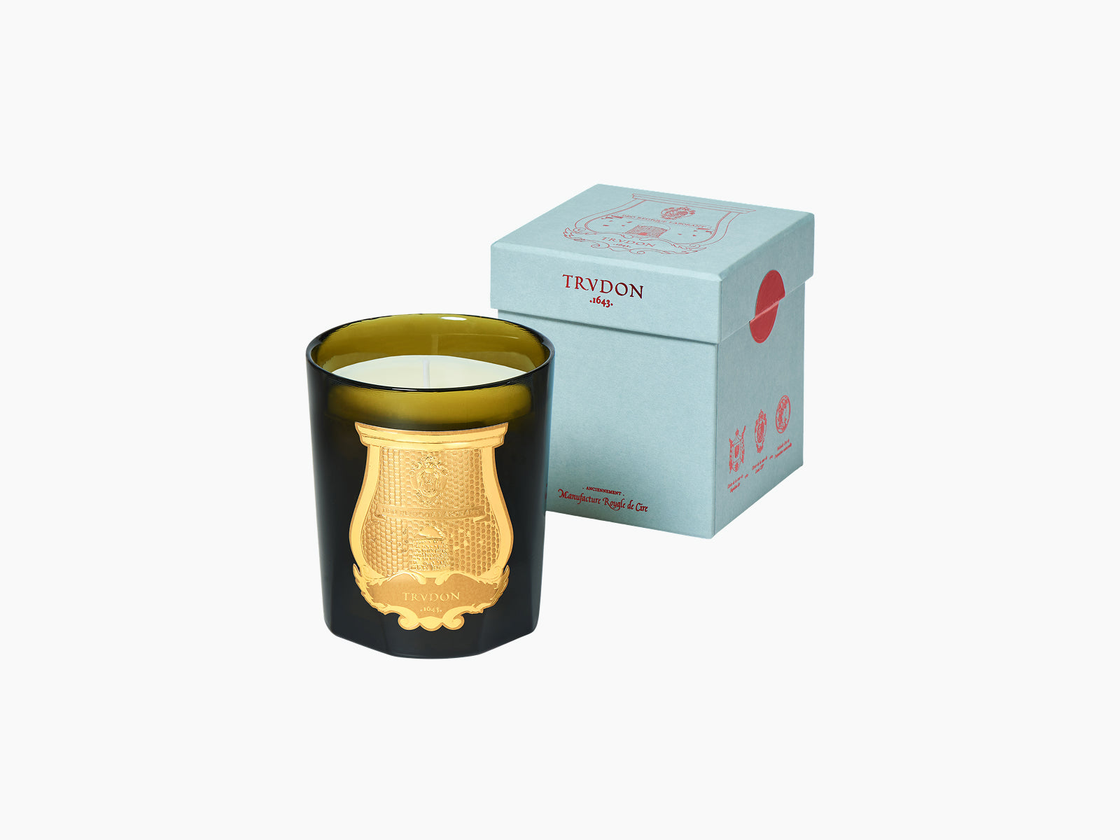 Joséphine Floral Garden candle in dark glass with gold crest beside a pale blue box.