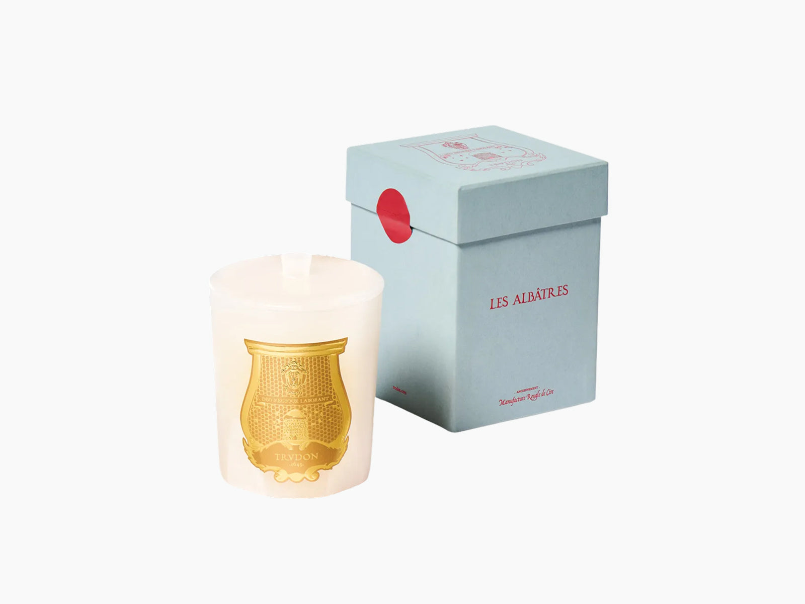 Gabriel The Alabasters candle in white alabaster with a gold emblem and lid beside a light blue box labeled Les Albatres