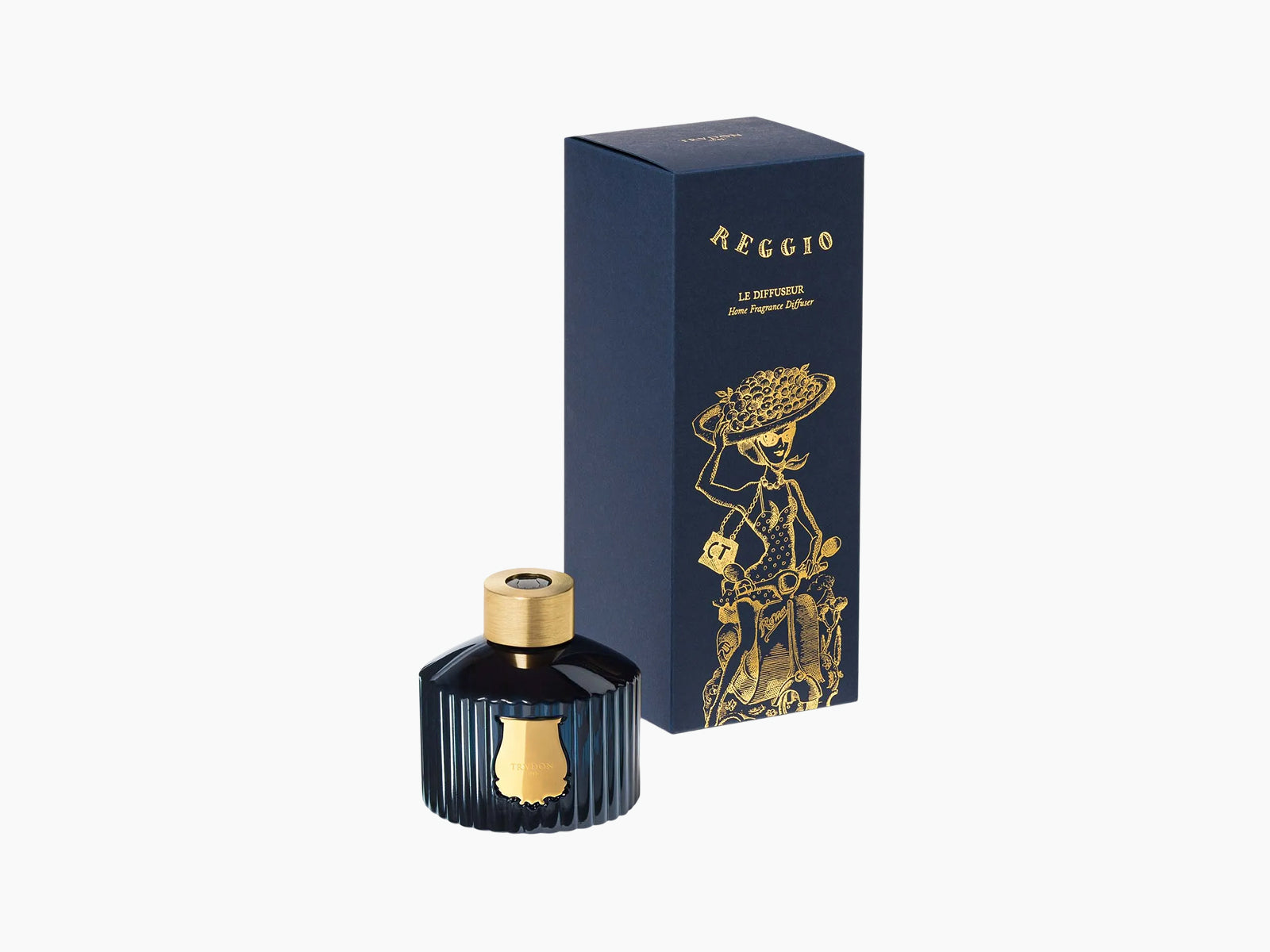 Reggio diffuser in dark blue ribbed glass with gold cap beside a navy box featuring gold illustration.