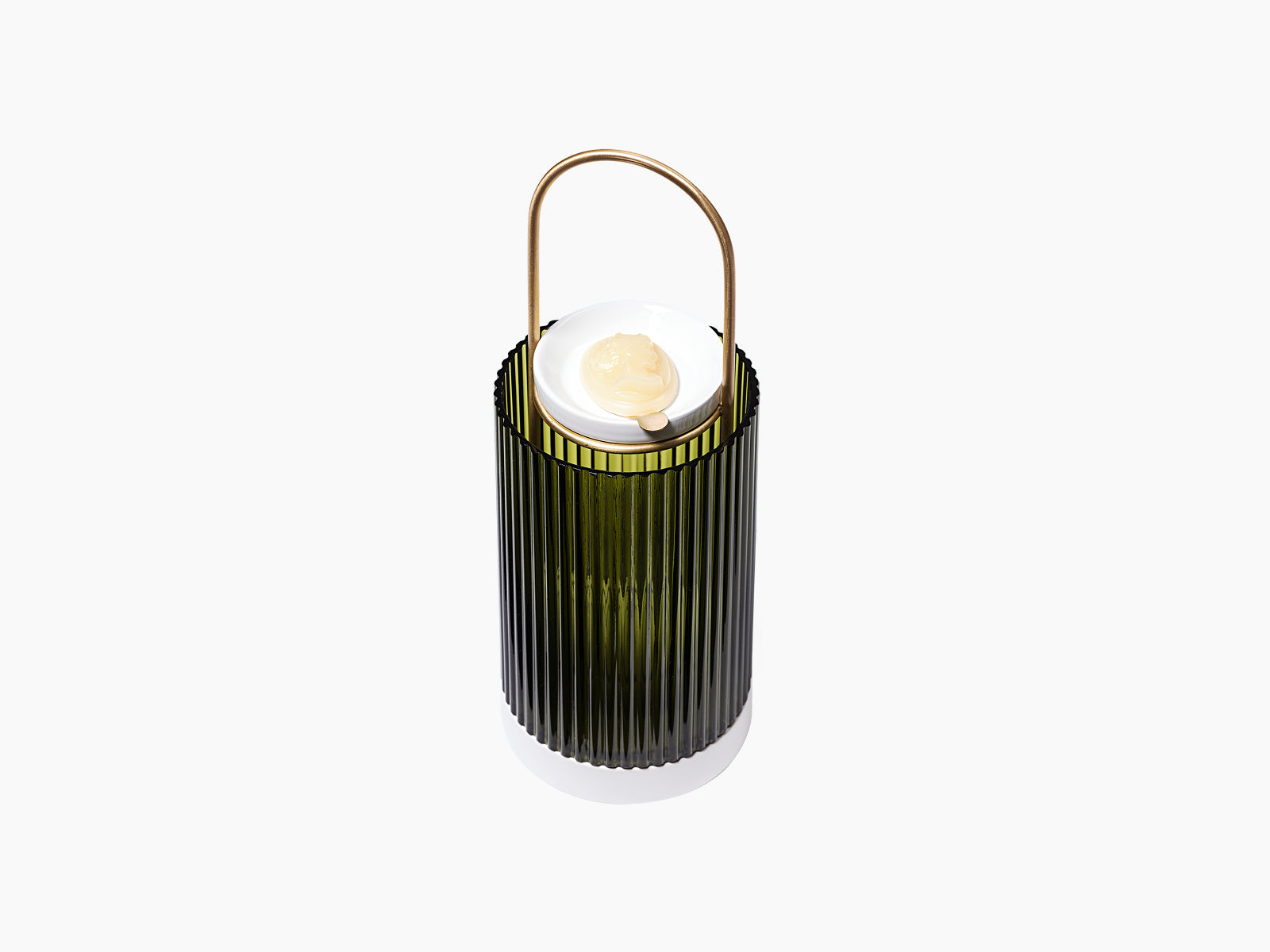 La Promeneuse base with ribbed dark green glass holder a white ceramic dish and pale wax cameo on top.