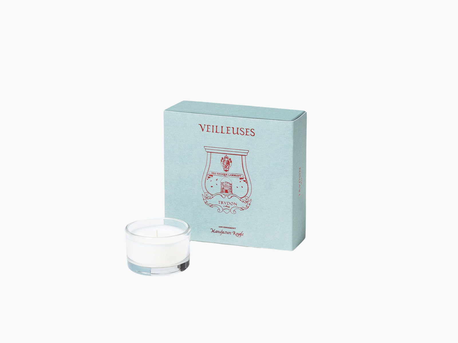 Pale blue box with red emblem and VEILLEUSES text beside a small clear glass night-light candle.
