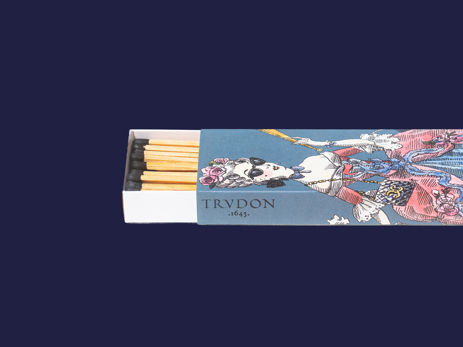 Scented matches in a pink illustrated box showing a stylish woman in a green coat and purple hat beside a bicycle