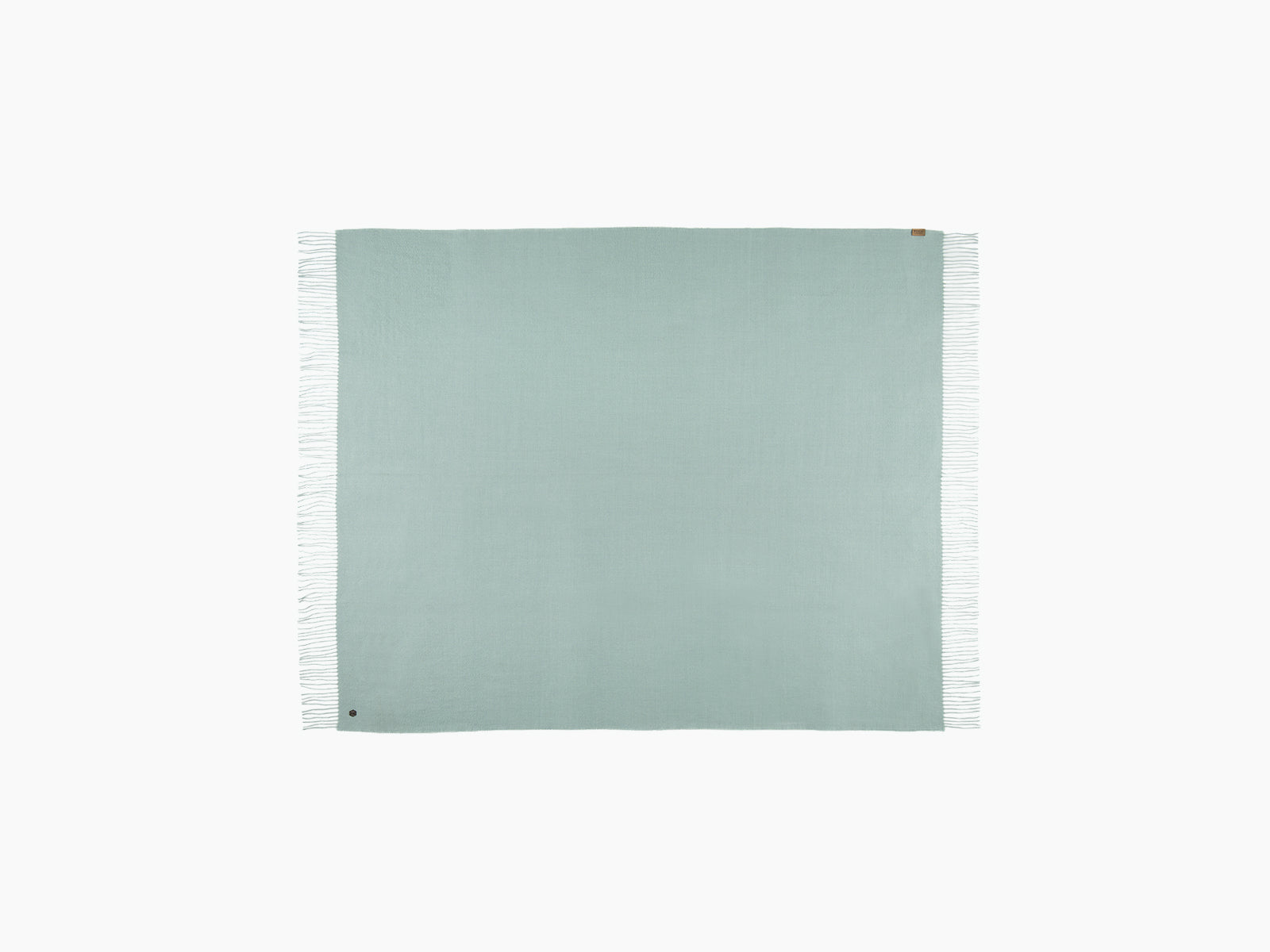 Folded mint green Plaid ALMA alpaca blanket with fringed edges and corner tag