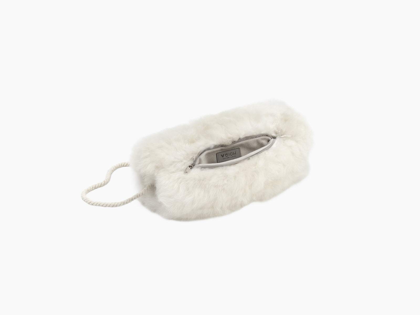 Cream white alpaca pocket muff with a zip opening and visible inner label