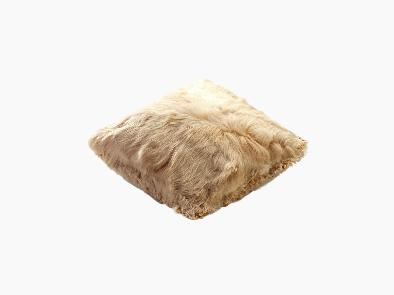 Beige alpaca cushion lying flat with fluffy fur and silky texture