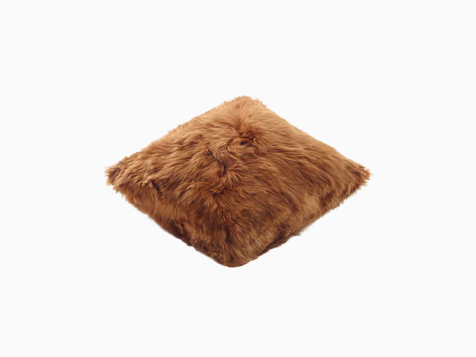 Soft beige fluffy alpaca pillow resting on a white studio background.