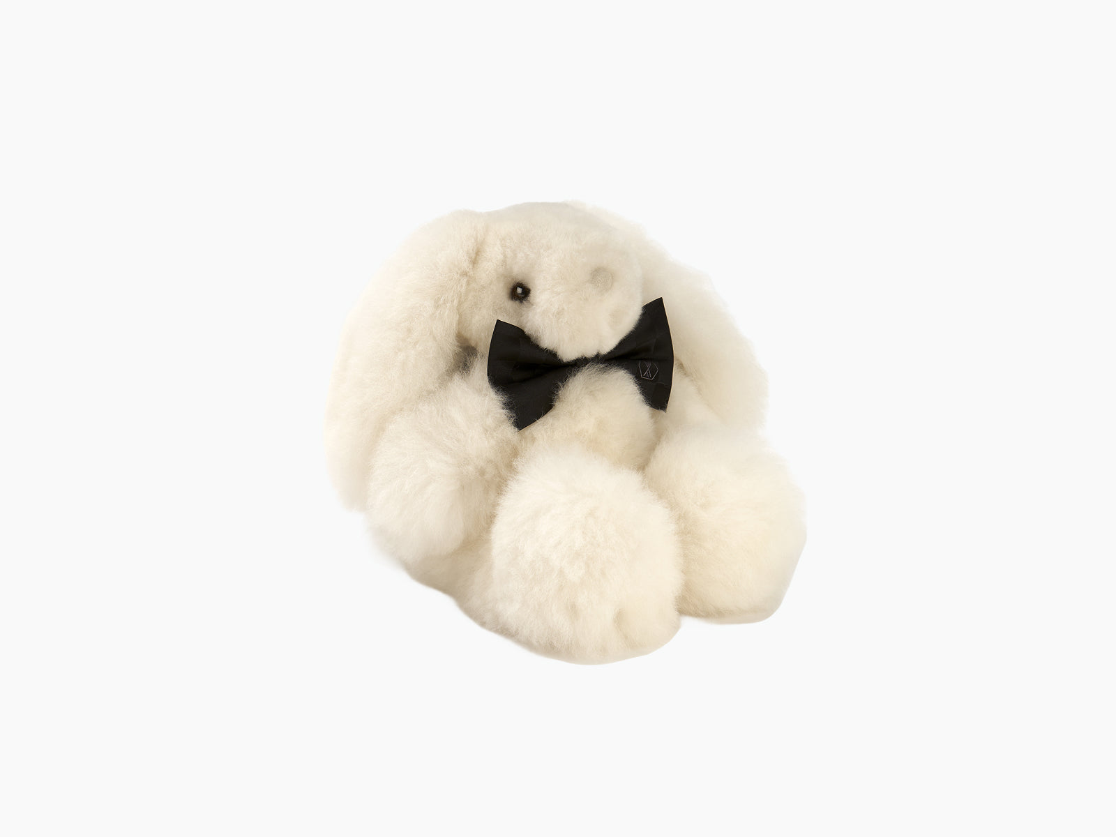 Cream Milo rabbit plush with black bow tie made from fluffy alpaca fibre