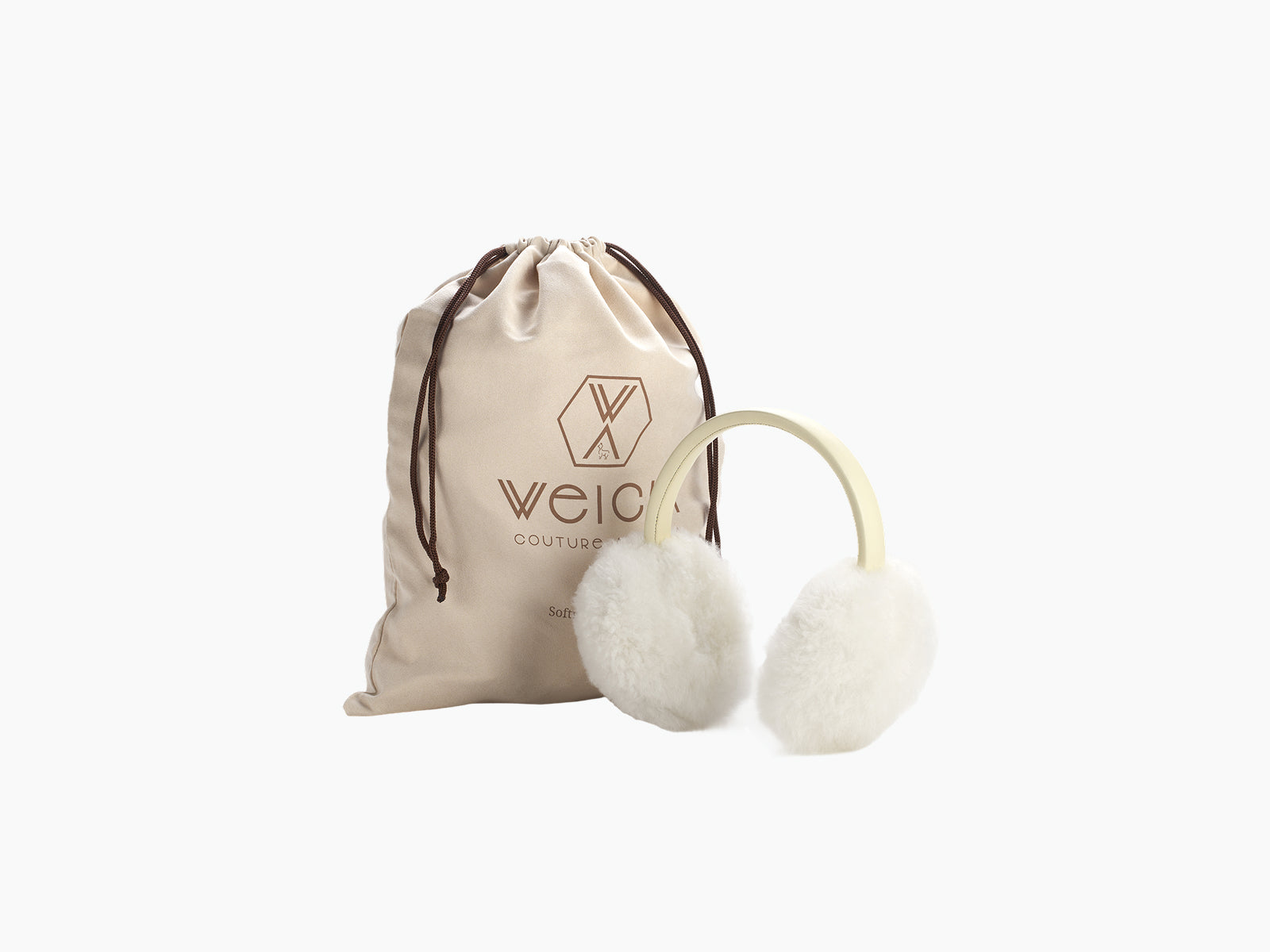 OLMO ear warmers with fluffy white fur and a pale leather band beside a beige drawstring pouch bearing WEICH couture