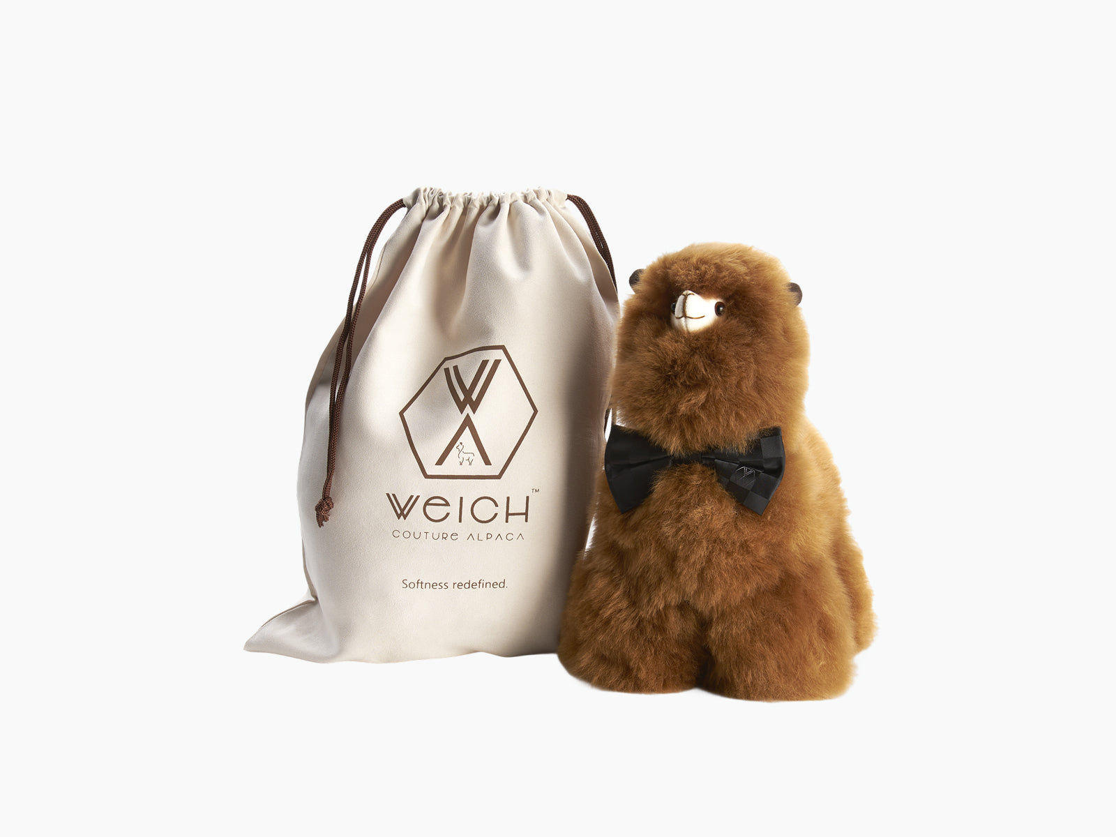 Light gray plush alpaca with a black bow tie against a white background