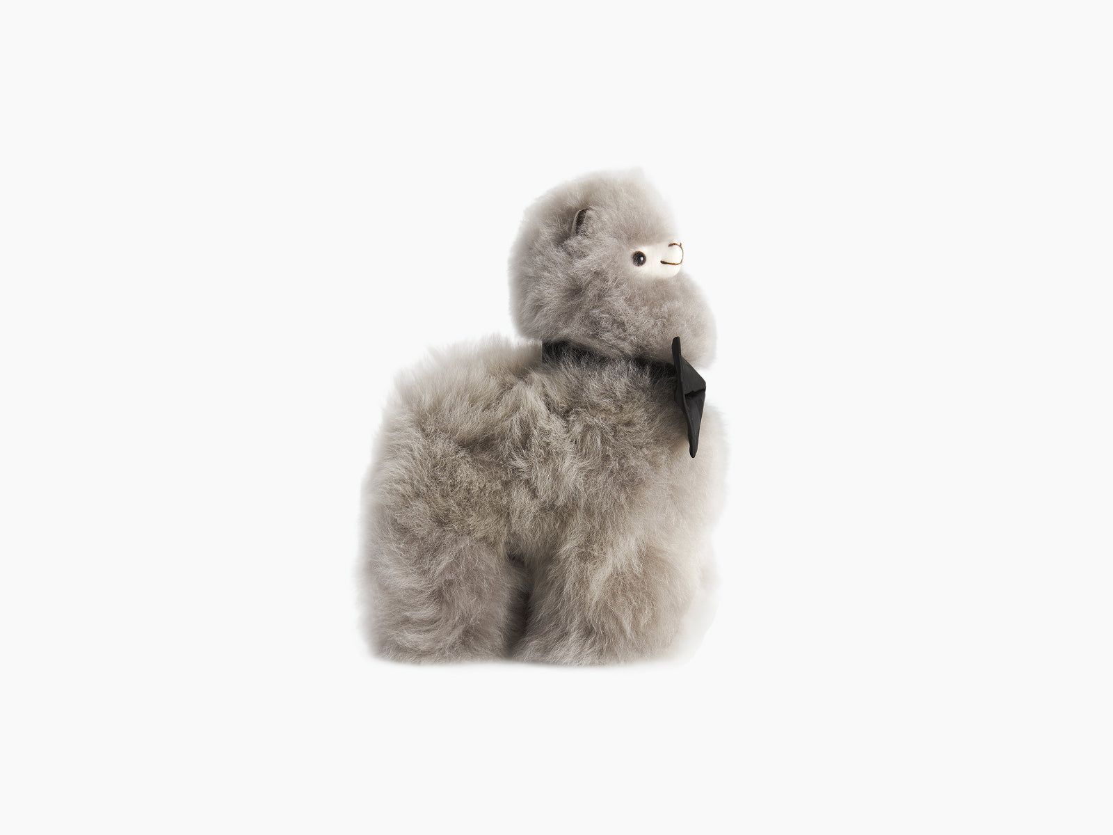 Gray fluffy alpaca plush with a black bow tie beside a beige drawstring bag bearing the WEICH logo