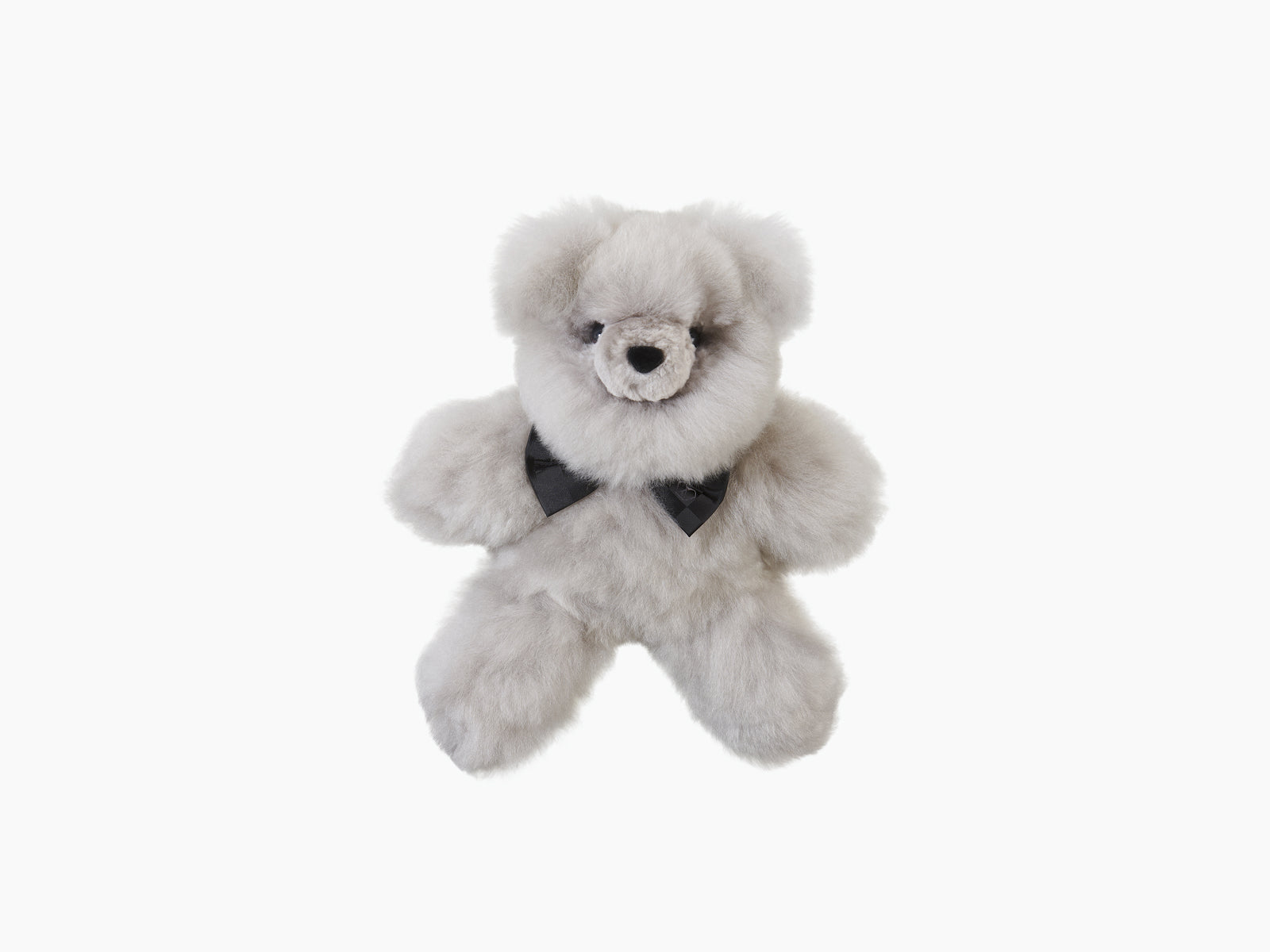Light gray plush teddy bear with a black silk bow tie