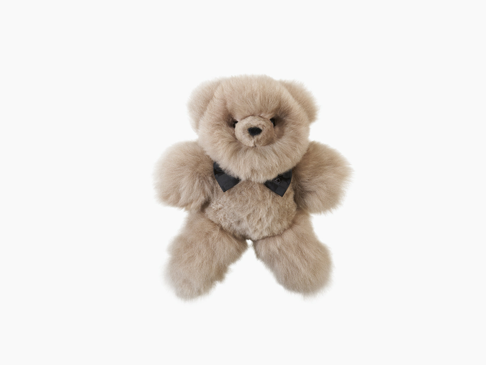 Beige plush teddy bear with a black silk bow tie