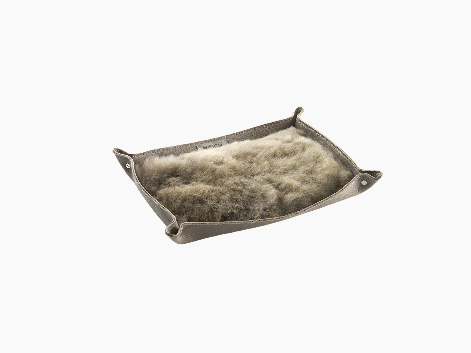 Taupe leather catchall tray viewed from above with fluffy alpaca lining and stitched edges
