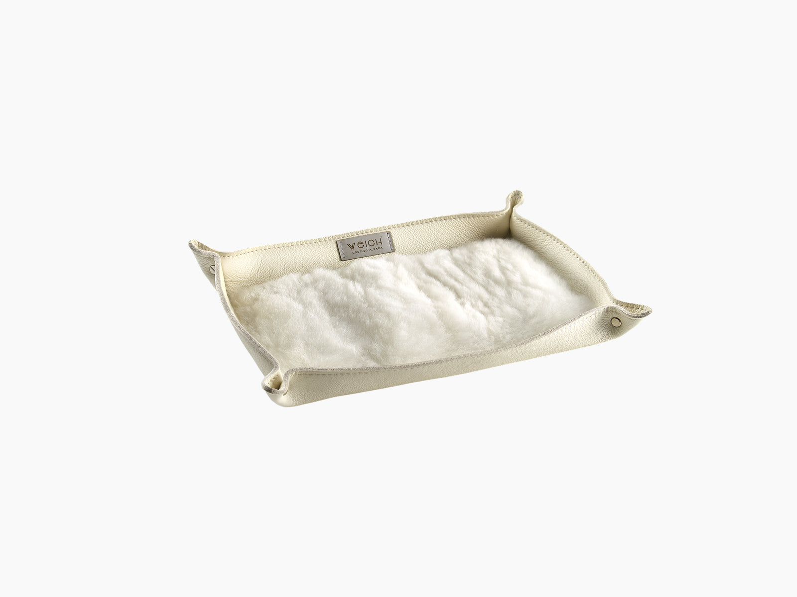 Cream leather catchall tray with soft white alpaca lining and a WEICH label