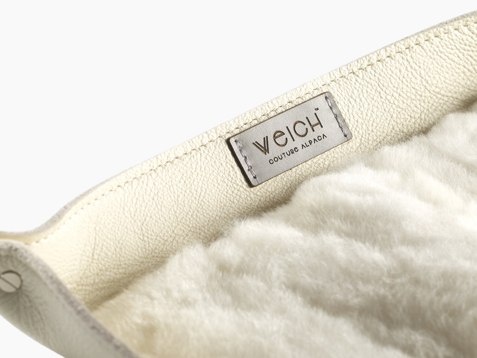 Beige leather edge and soft white alpaca lining inside a WEICH catchall tray